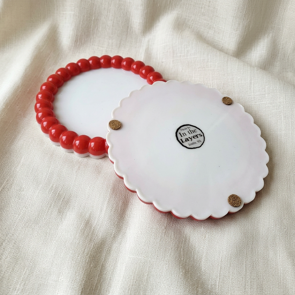 Your red-and-white pieces on a soft ivory linen background